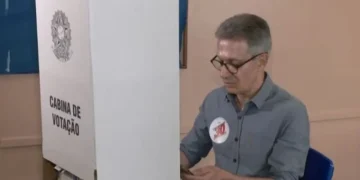 Romeu Zema utiliza celular na cabine de votação (Crédito: GloboNews)